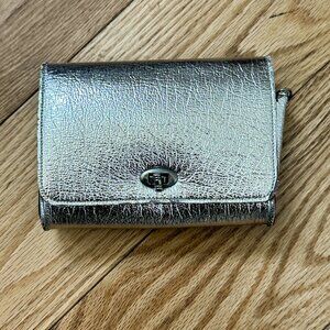 3.	Sparkly metallic silver-color, tiny clutch purse with turn-twist closure